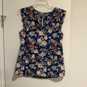 Adorable tank size small. Floral print but primary colors are blue and peach.